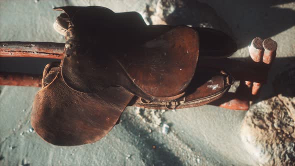 Rider Leather Saddle on Fence in Desert