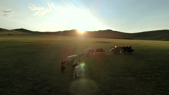 Central Asian Family People Walking Immigrating With Traditional Old Oxcart Tumbrel And Tumbril Cart