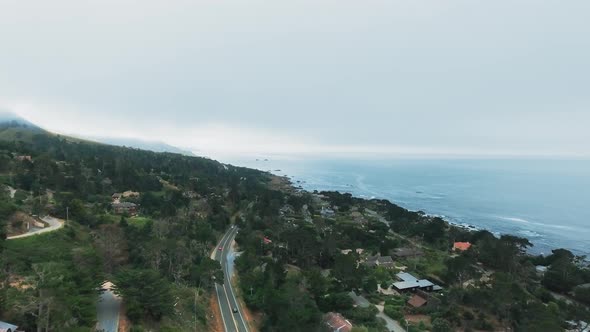 Drone shot of the city near the ocean, cars, roofs of houses (California, USA)