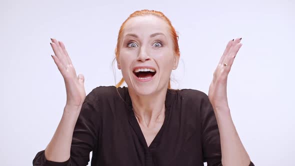 Surprised Caucasian Female with Colored Orange Hair Actively Waving Hands Screaming Wow on White