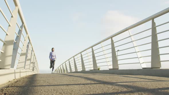 Woman wearing hijab running outside