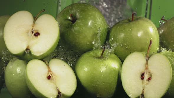 Slow Motion Shot of Green Apple Water Splashing Through Apple Slices