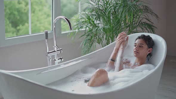 Relaxed Woman Washing Hands in Bath in Slow Motion