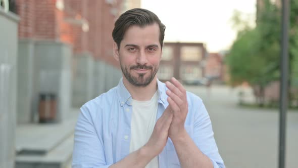 Man Clapping While Standing Outside