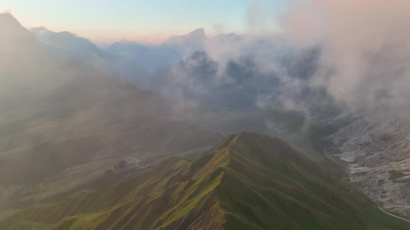 Sunrise in the Dolomites mountains with fog and mist