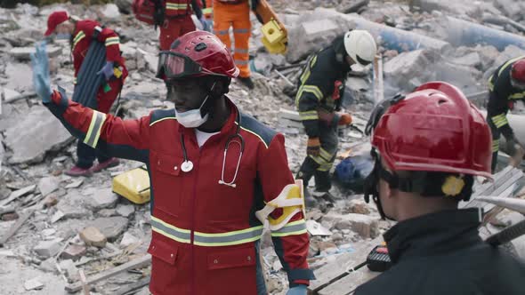 Black Rescuer Speaking with Colleague