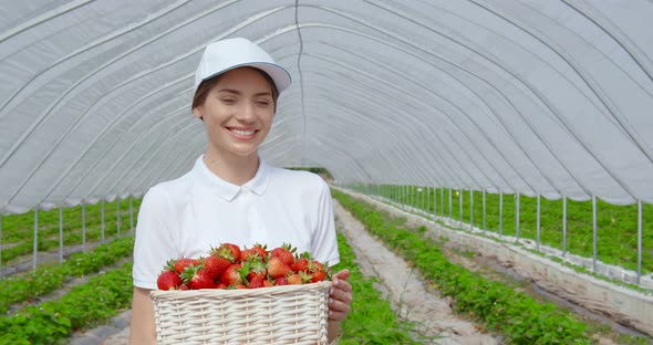 Portrait of Woman with Basket of Strawberries in Hands