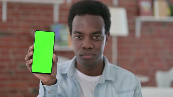 African Man Holding Smartphone with Chroma Screen 