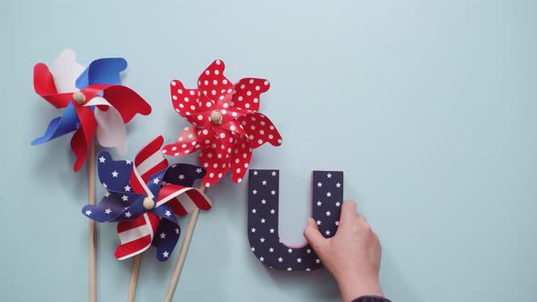 July 4th theme paper pinwheels on blue background.