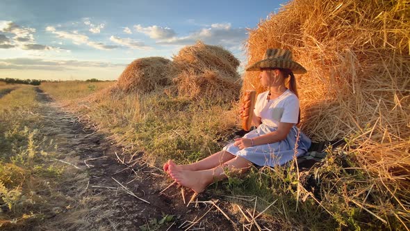 Hungry Child Eating Bread in Wheat Field, Summer Outdoor Lifestyle.