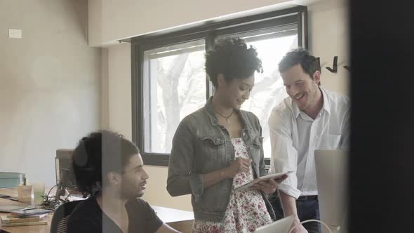 Colleagues chatting in office