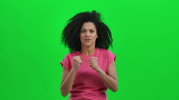 Portrait of Young Female African American Looking at Camera with Excitement and Anticipation Then