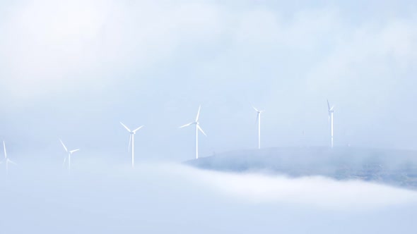 Wind Turbines in Foggy Landscape