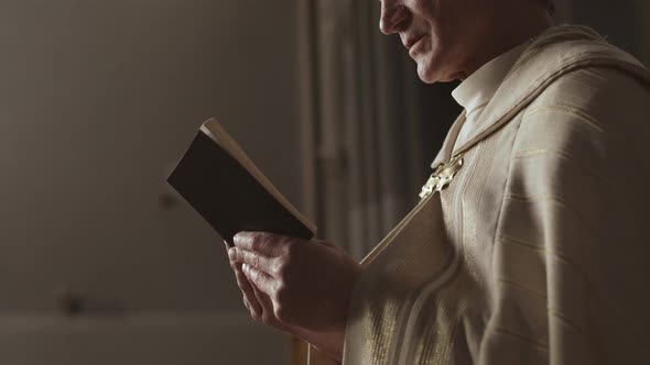 Unrecognizable Old Pastor Reading Holy Bible
