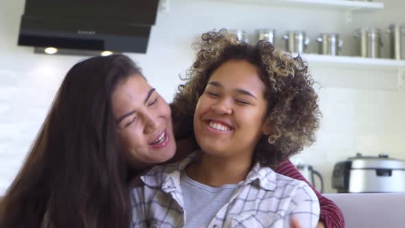 Girlfriend Asian Hugs Her AfricanAmerican Girlfriend From Behind