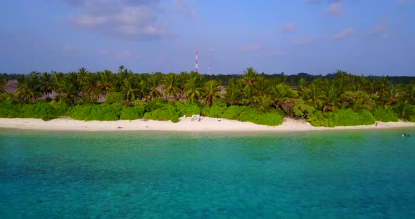 Beautiful above travel shot of a summer white paradise sand beach and blue sea background in 4K