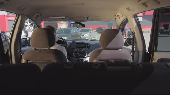 Woman in Face Mask Entering Taxi