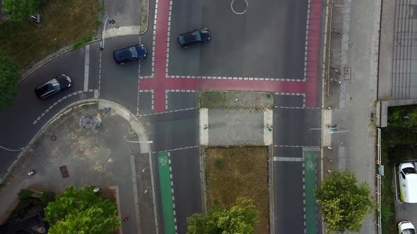 Cars turn left at an intersection on a roadDaring aerial view flight bird's eye view drone footage