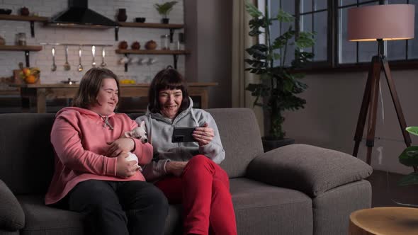 Happy Disabled Child with Mother Relaxing at Home