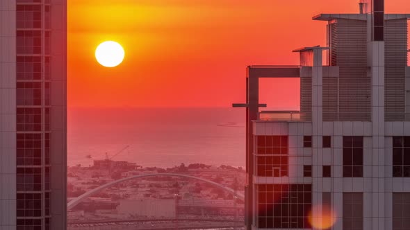 Sunset Behind Modern Residential and Office Complex Aerial Timelapse at Business Bay Dubai