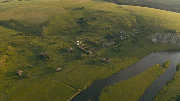 Aerial View of the River with a Rock and Forest on the Banks