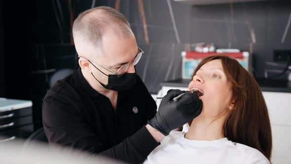 An Orthodontist Checks the Braces and Jaws of a Woman