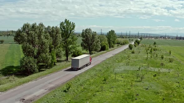 Aerial Top View of Truck with White Cargo Semi Trailer Moving on Road