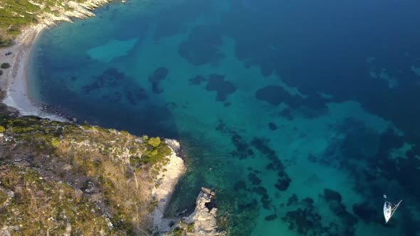 View From Above Aerial View of a Boat Sailing on a Transparent and Turquoise Sea