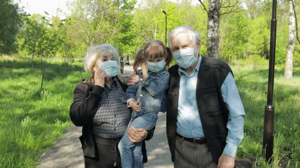 Grandparents with Granddaughter Takes Off Masks After Coronavirus Quarantine End