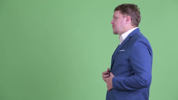 Profile View of Happy Overweight Bearded Businessman Talking