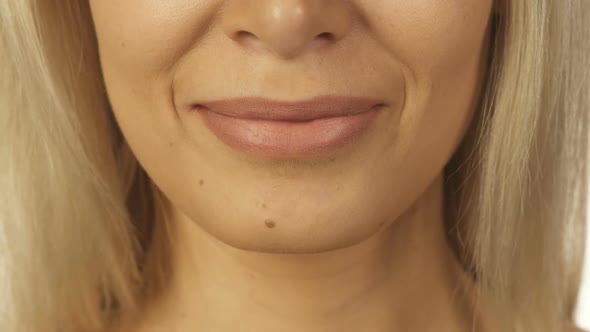 A Sweet Girl Brings Her Index Finger To Her Mouth and Shows a Sign of Silence