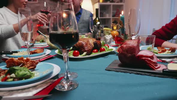 Father Slicing Chicken at Christmas Celebration