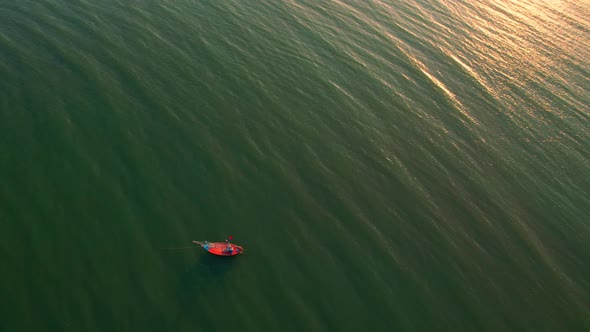 Aerial drone view of a fisherman boat in the sea near the coast.