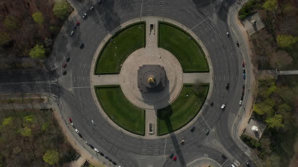 AERIAL: Overhead Birds Eye Drone View Rising Over Berlin Victory Column Roundabout with Little Car