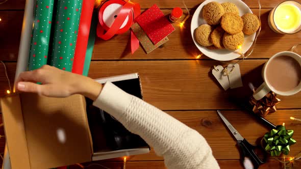 Woman Wrapping Camera for Christmas Gift