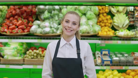 Portrait of a Young Smiling Woman Working in an Organic Store Female Looks at the Camera