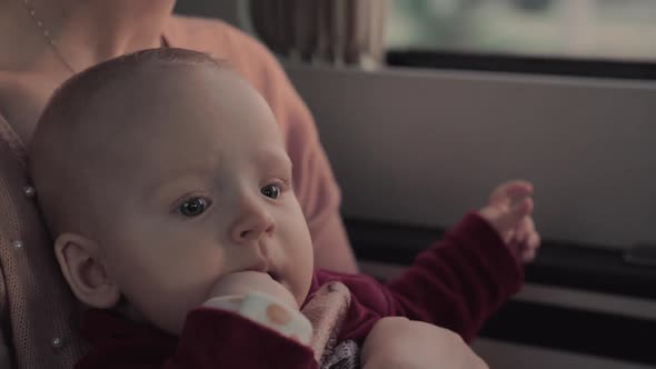 Baby Girl in Car with Fingers in Her Mouth