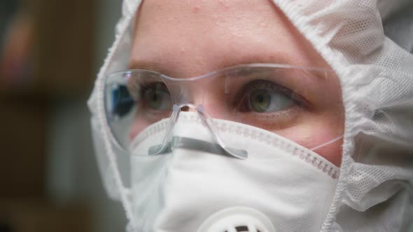 Closeup of Overworked Doctor or Researcher Dressed in Protective Suit Ppe Mask in Laboratory in