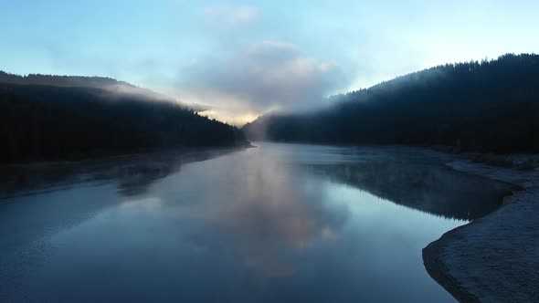Aerial View of Mountain Misty Lake in Sunrise Lights. Flying Above Water alt