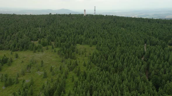 Aerial view of forest, tower and mountains, 4k drone.