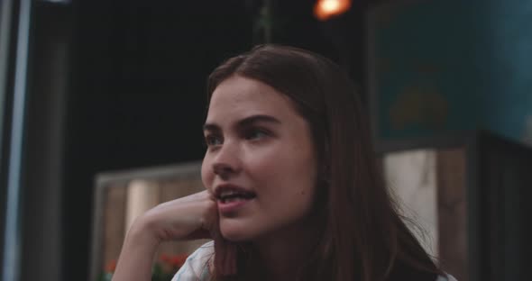 Young woman on a dinnner date talking and smiling