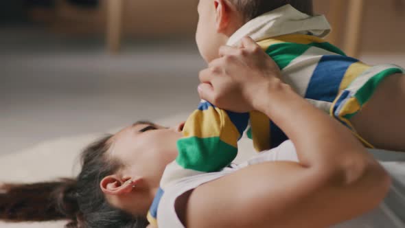 Asian Mother Speaking with Playful Son