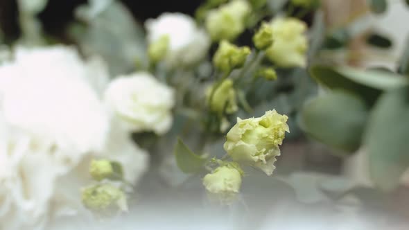 Closeup Bouquet of Fresh White and Yellow Roses with Green Leaves Closeup Slow Motion