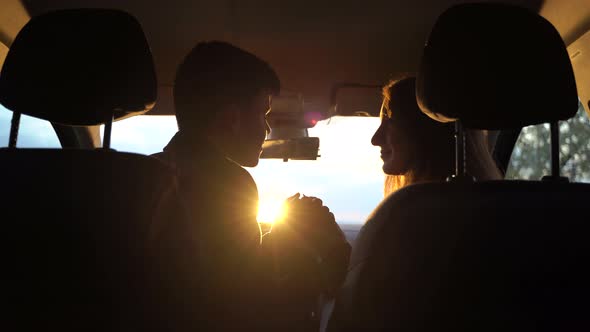 Young Man and Woman Holding Hands and Looking at Each