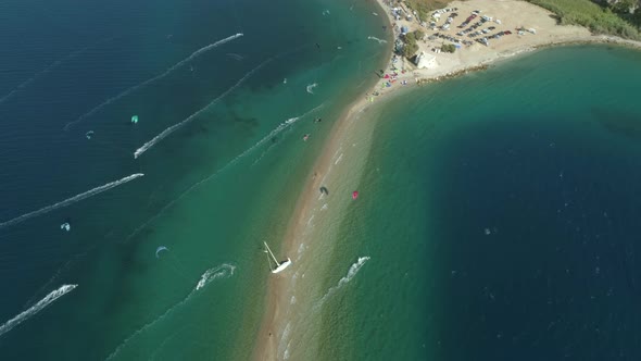 Aerial view faraway of group kitesurfing at Gulf of Patras, Greece.