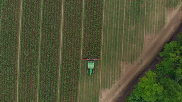 Aerial: Tractor Working on Cultivated Fields Farmland, Industrial Agriculture Occupation