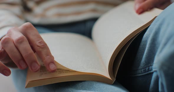 Closeup of Female Hands Turning Page Book alt