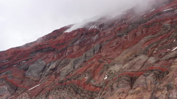 Video showing the grey brown and red colored stony layers and a gletser