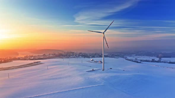 Wind turbine and snowy field in winter. Alternative energy, Poland.