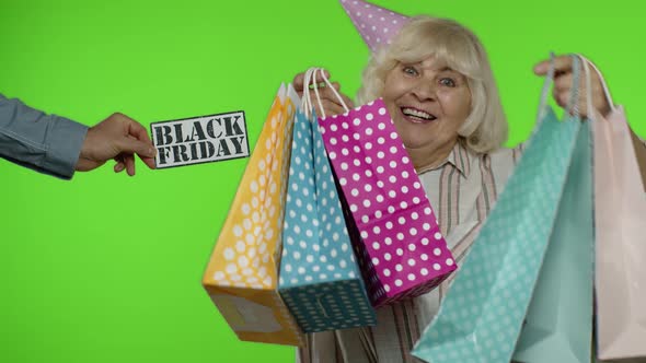 Advertisement Inscription Black Friday Appears Next To Joyful Grandmother with Shopping Bags